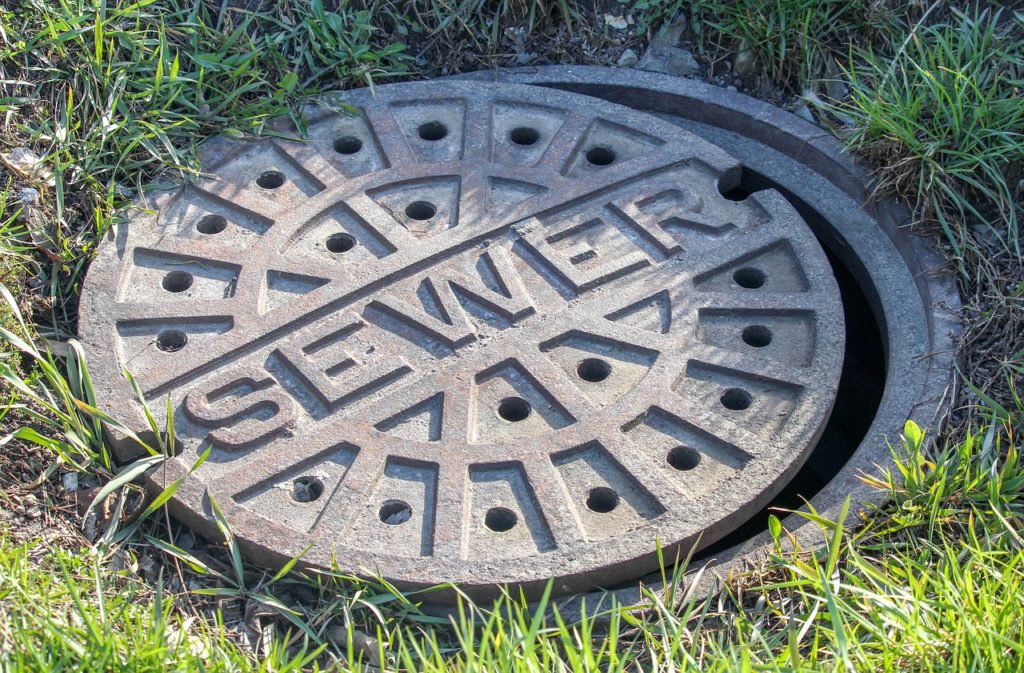 Sewage and Drains Photo by GregReese on Pixabay https://pixabay.com/en/sewer-grass-old-outdoors-round-3305945/